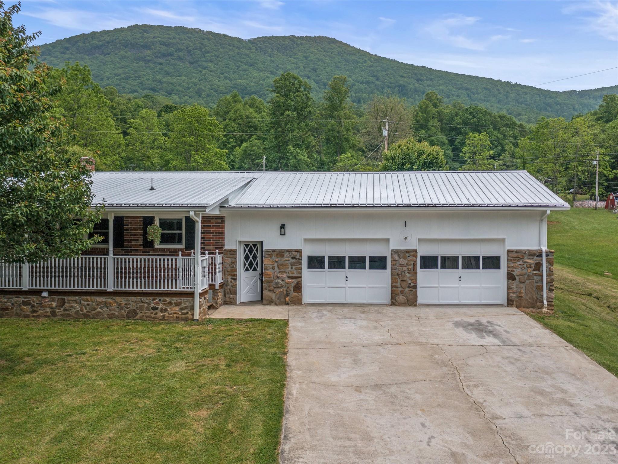70 Letterman Road Green Mountain, NC 28740 - Photo 23 of 23 a view of a house with a yard and potted plants