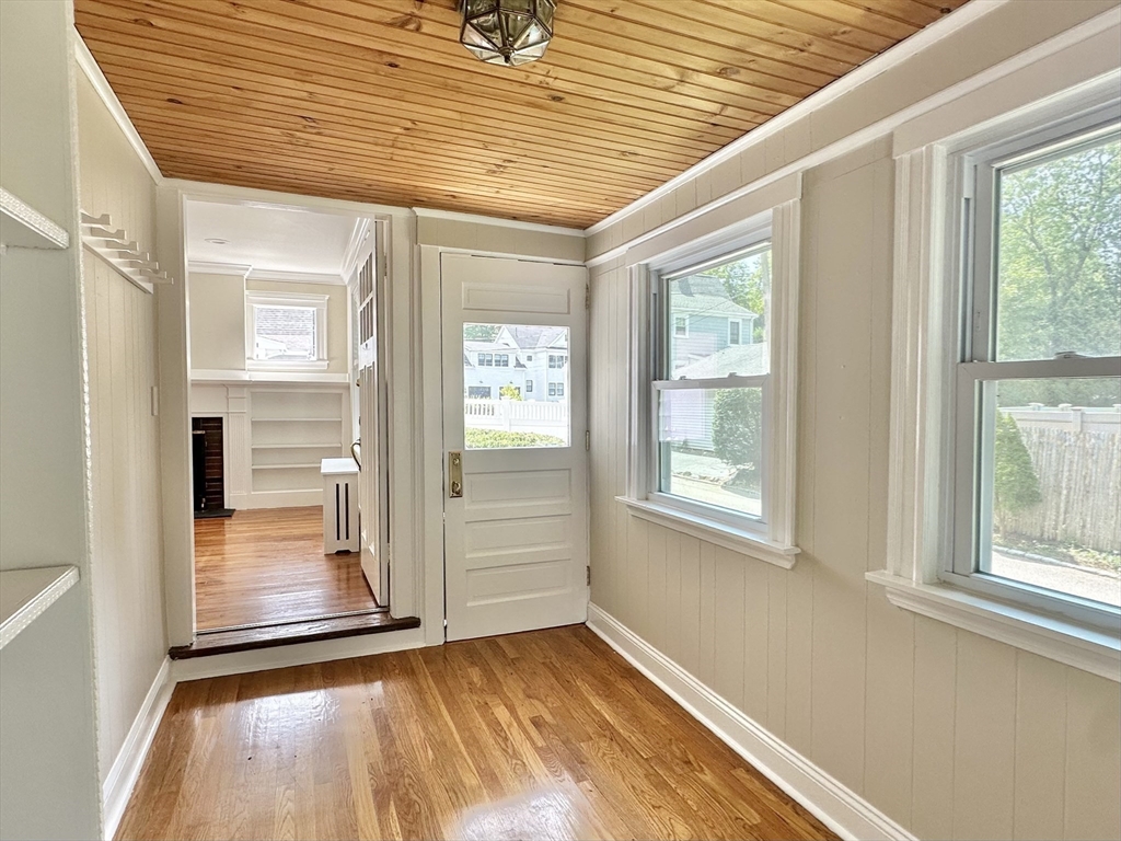 8 A Mellon Road Wellesley, MA 02482 - Photo 7 of 22 a view of an empty room with wooden floor and a window