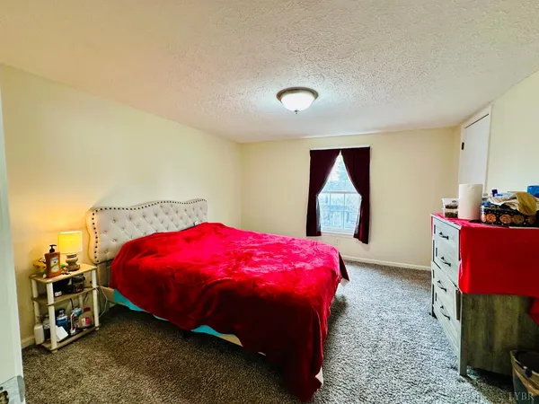 a bedroom with a bed and a mirror