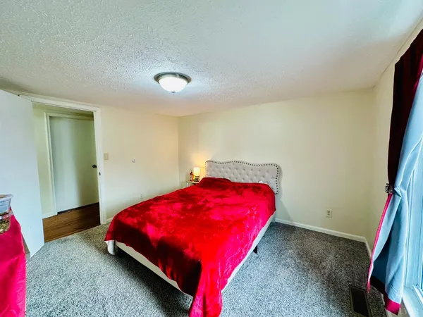 a bedroom with a bed and a mirror