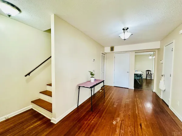 a view of a hallway view with wooden floor and staircase