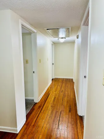a view of a room with wooden floor and staircase