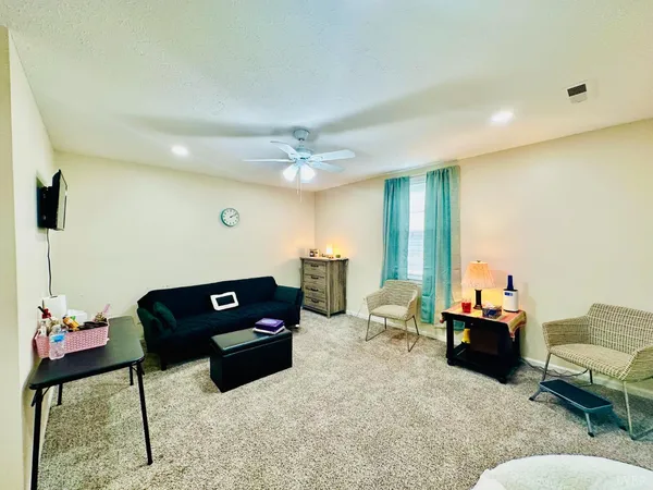 a living room with furniture and a chandelier