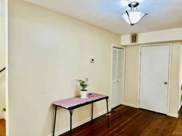 a view of a room with wooden floor and cabinet