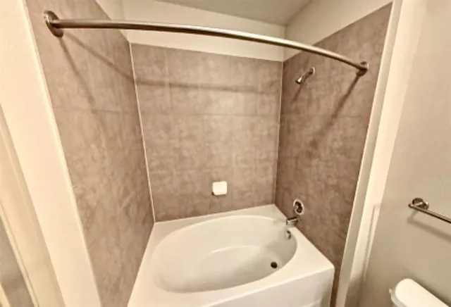 a bathroom with a bathtub sink and toilet