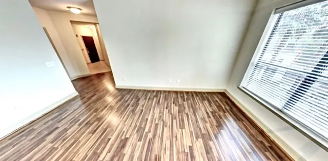 a view of wooden floor in a bathroom with mirror
