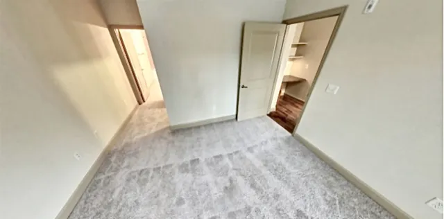 a view of a kitchen with kitchen island wooden floor stainless steel appliances and window