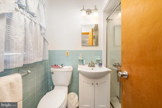 a white toilet sitting next to a bathroom sink