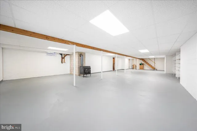 a view of swimming pool with lounge chair and dinning table under an umbrella