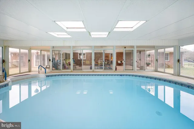 a view of a swimming pool with a yard