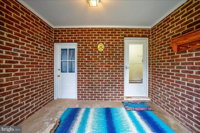 a view of a patio with a table and chairs and wooden floor