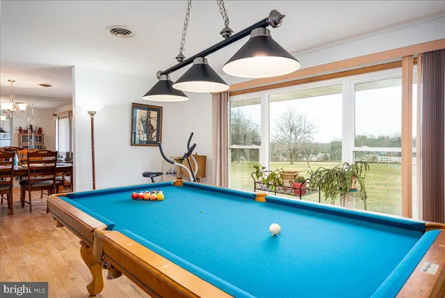 a living room with furniture a flat screen tv and a flat screen tv