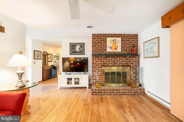 a kitchen with a sink a refrigerator and white cabinets