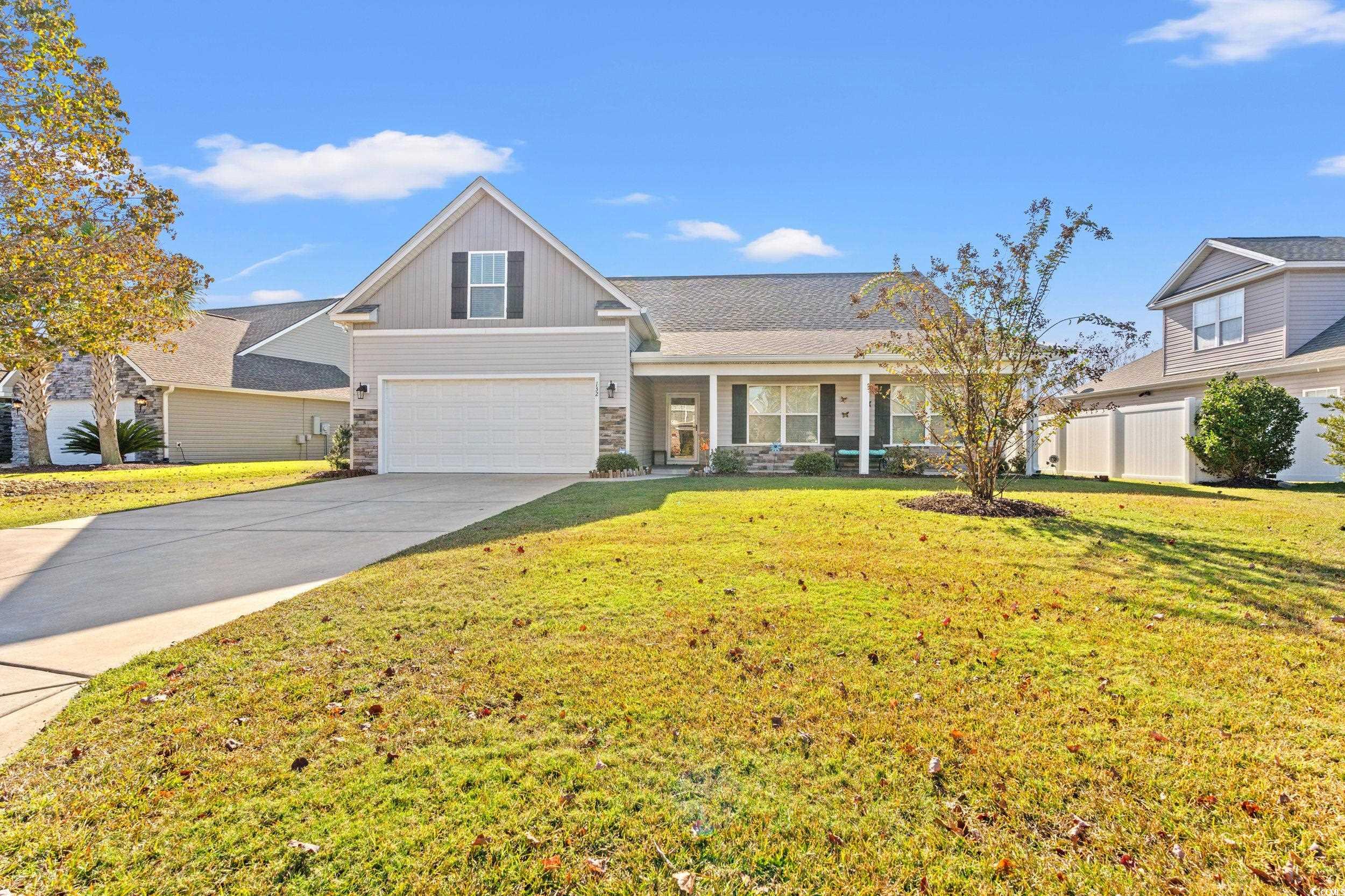 132 Fox Den Drive Murrells Inlet, SC 29576 - Photo 27 of 35 Traditional-style house with covered porch, concrete driveway, stone siding, and a garage