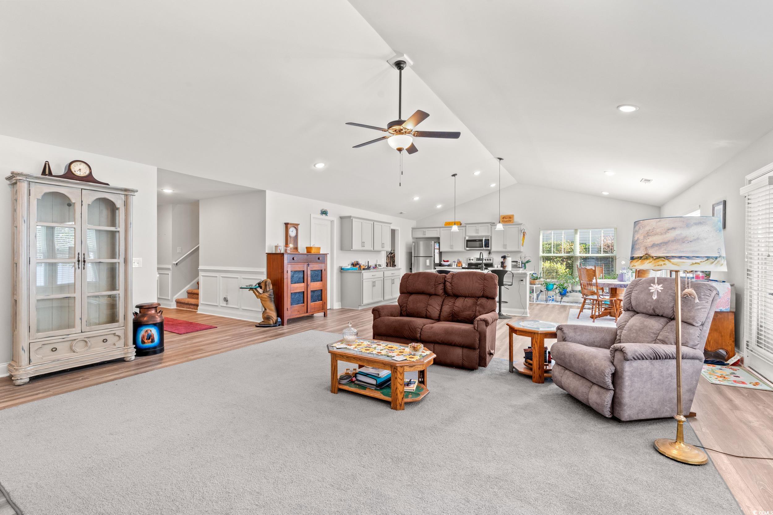 132 Fox Den Drive Murrells Inlet, SC 29576 - Photo 4 of 35 Living room featuring lofted ceiling, wood finished floors, stairs, ceiling fan, and wainscoting
