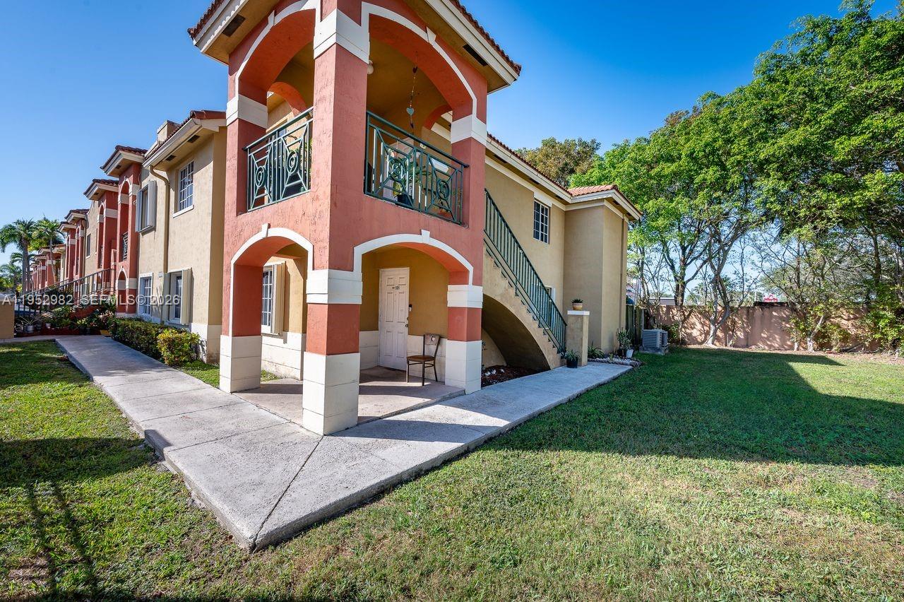 15250 Southwest 134th Place, Unit 102 Miami, FL 33177 - Photo 1 of 23 a front view of a house with garden