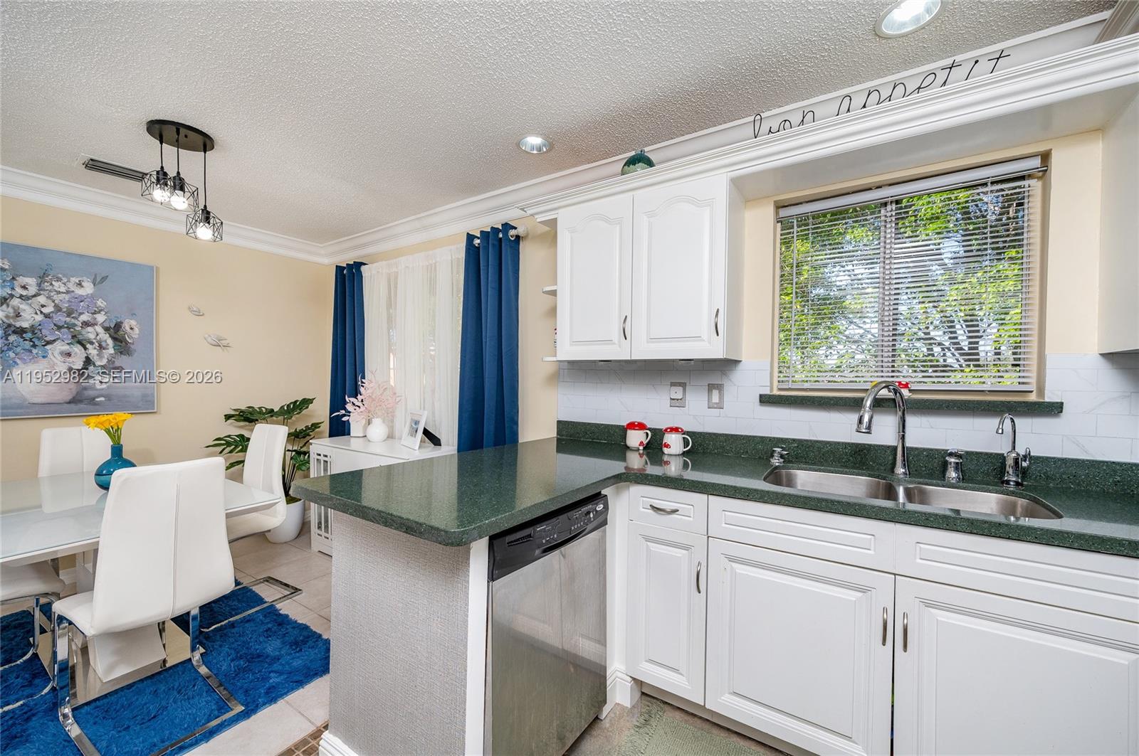 15250 Southwest 134th Place, Unit 102 Miami, FL 33177 - Photo 11 of 23 a kitchen with a sink cabinets and window