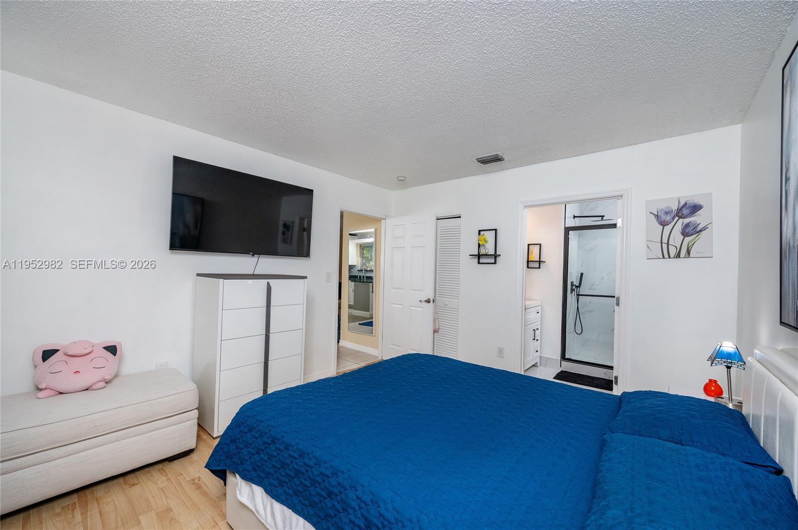 15250 Southwest 134th Place, Unit 102 Miami, FL 33177 - Photo 14 of 23 a bedroom with a bed and a flat screen tv