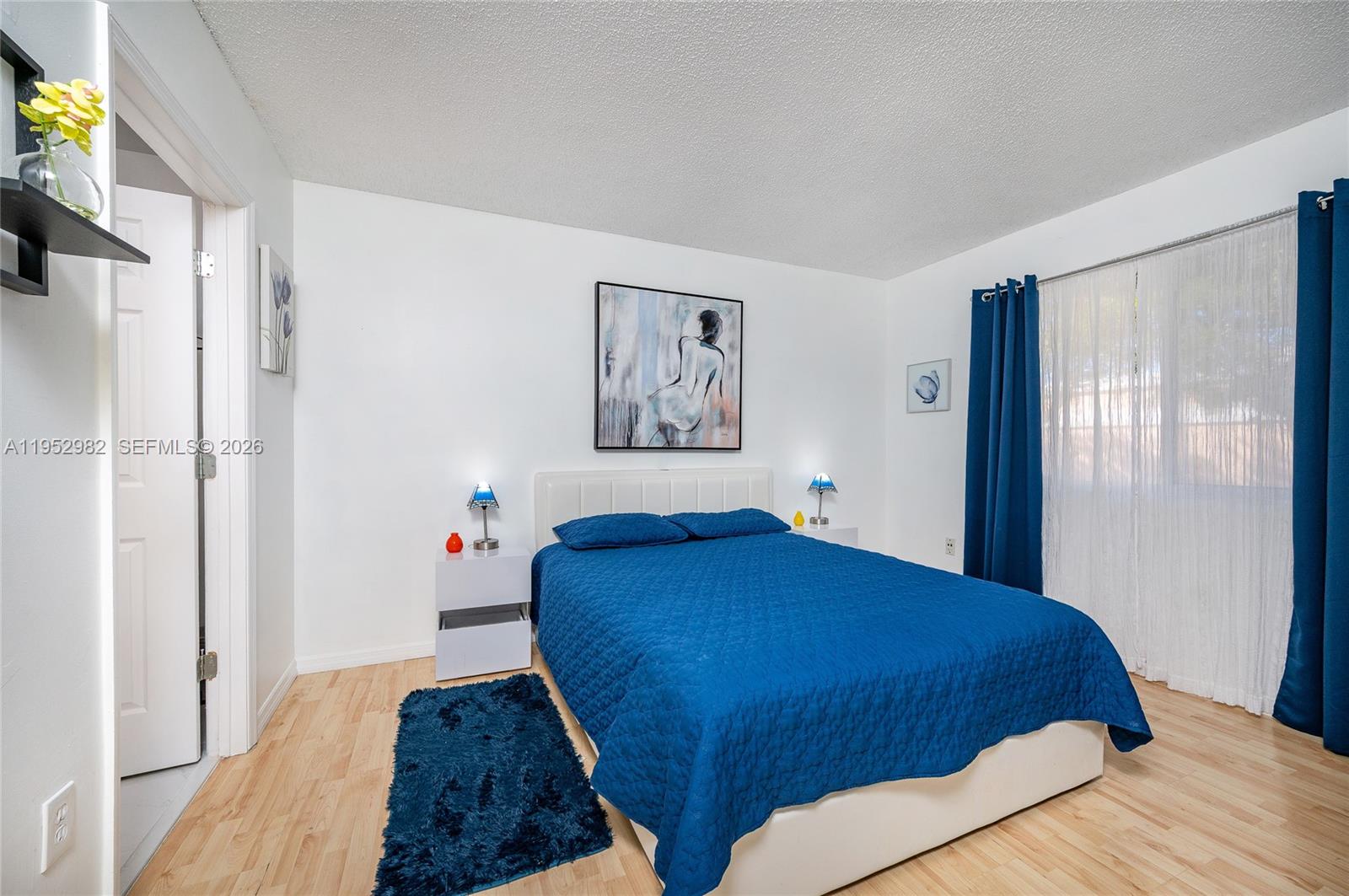 15250 Southwest 134th Place, Unit 102 Miami, FL 33177 - Photo 15 of 23 a bedroom with a large bed and a window