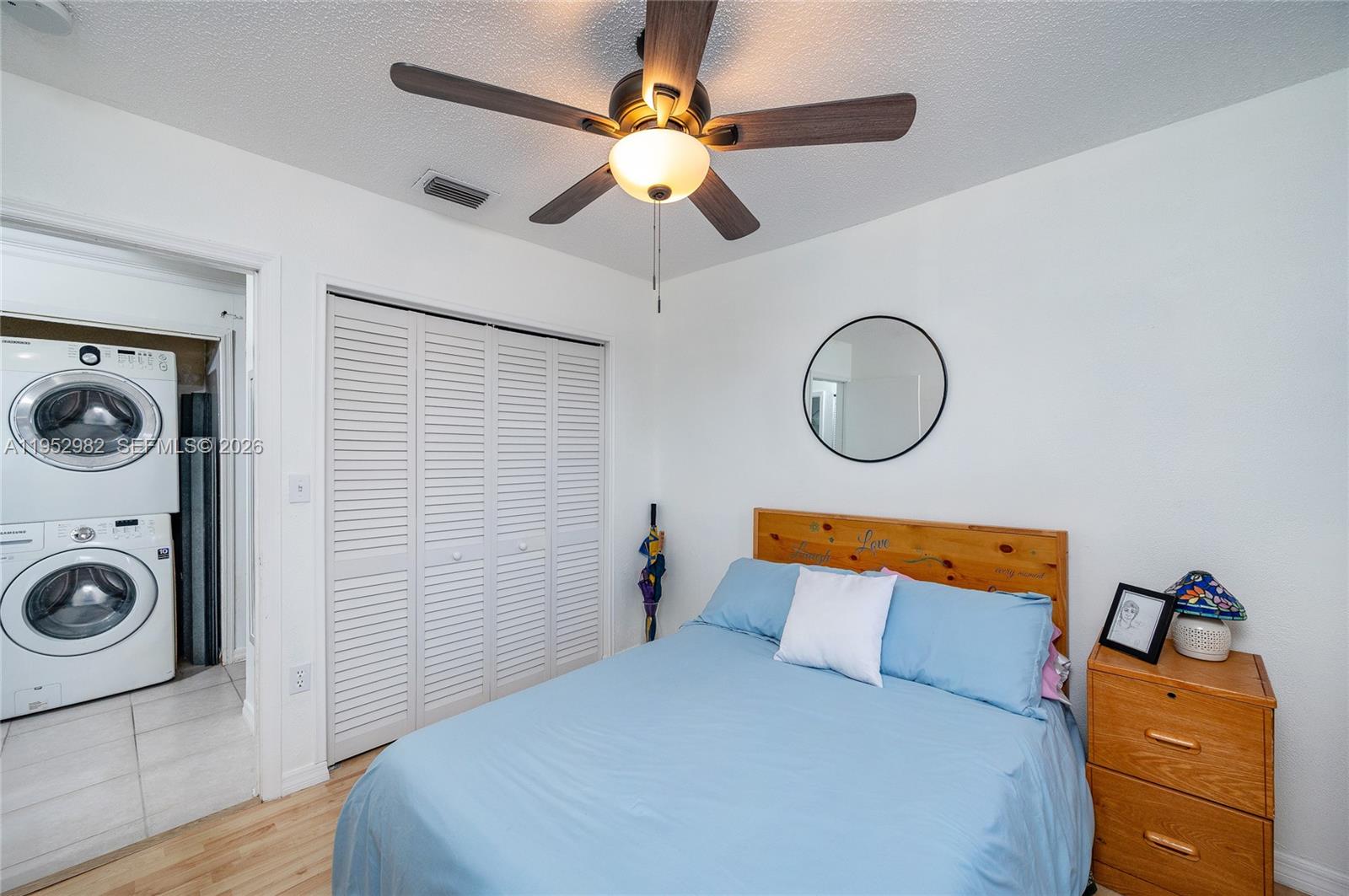15250 Southwest 134th Place, Unit 102 Miami, FL 33177 - Photo 18 of 23 a bedroom with a bed and a chandelier