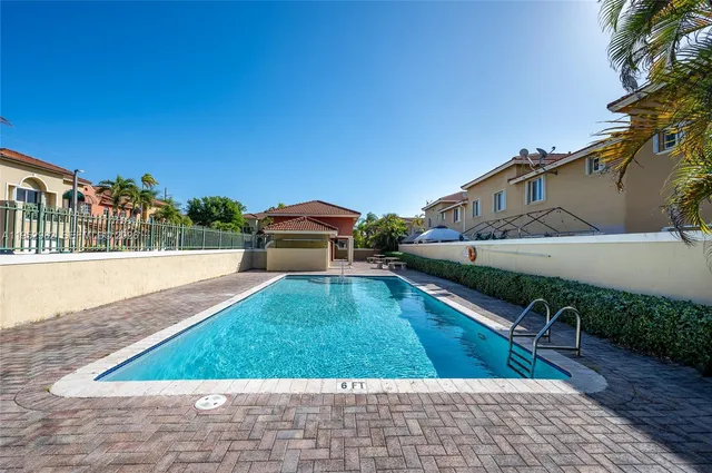 swimming pool view with a seating space