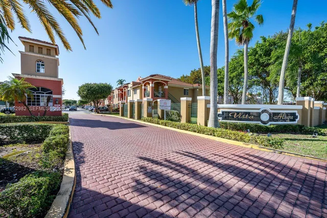 a view of a house with a yard and plants