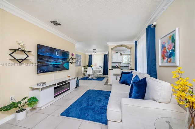 a living room with furniture and a flat screen tv