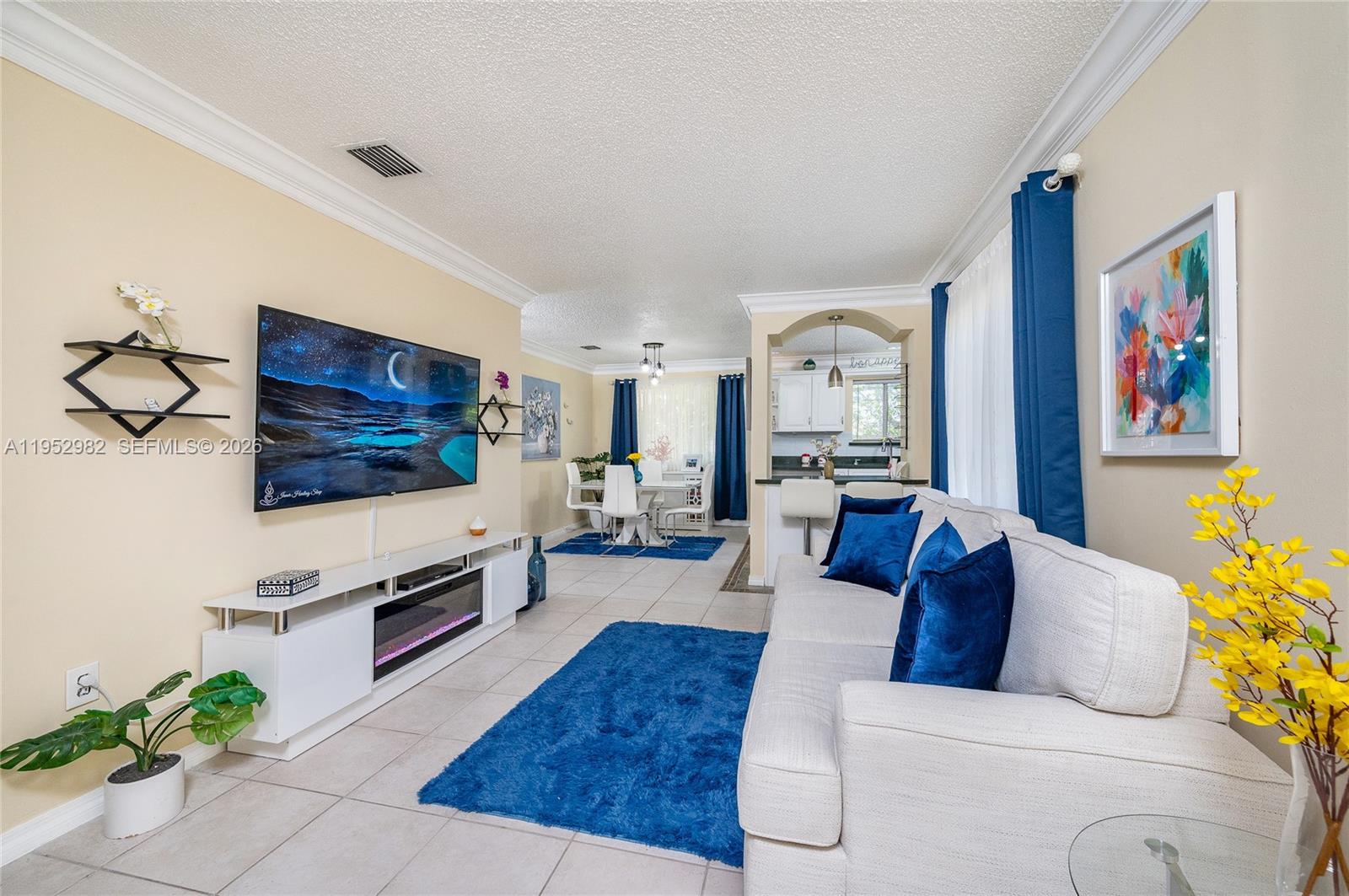 15250 Southwest 134th Place, Unit 102 Miami, FL 33177 - Photo 6 of 23 a living room with furniture and a flat screen tv