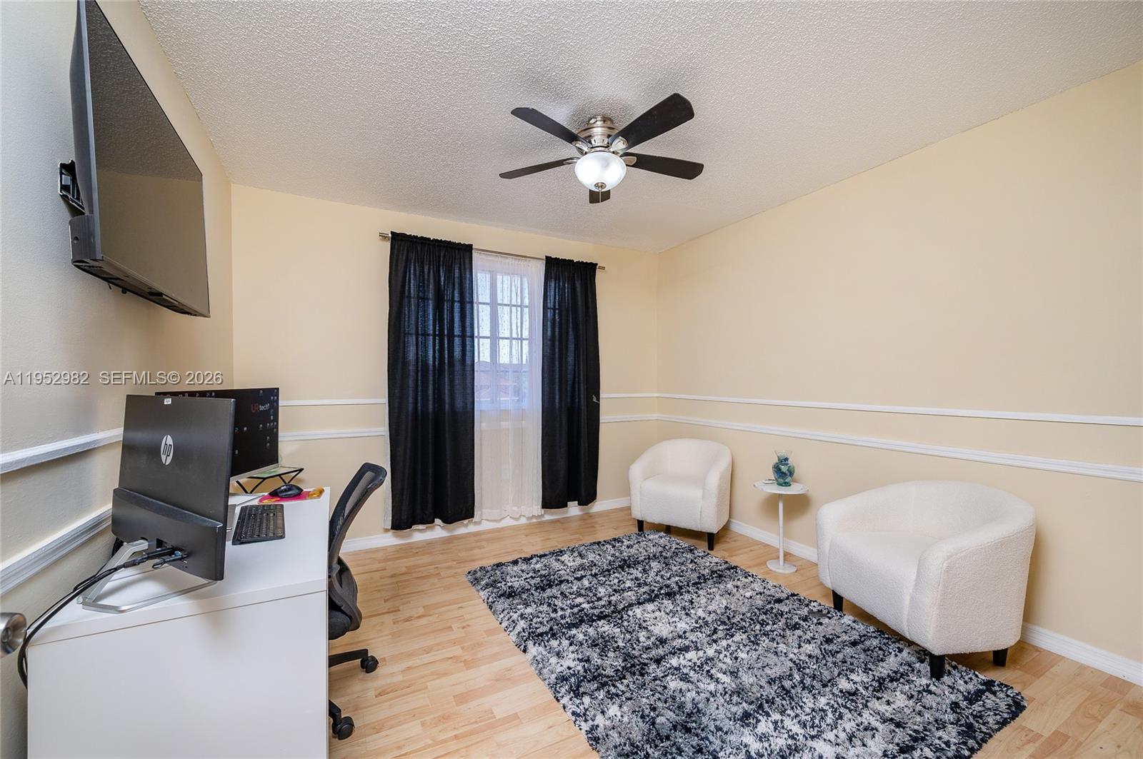 15250 Southwest 134th Place, Unit 102 Miami, FL 33177 - Photo 8 of 23 a bedroom with a bed and a chandelier