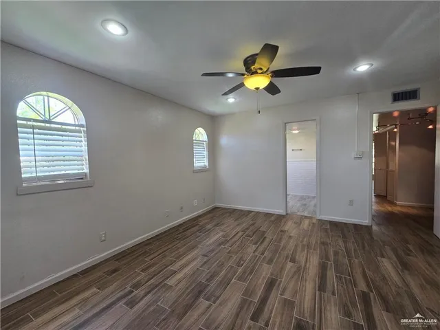 an empty room with wooden floor and closet