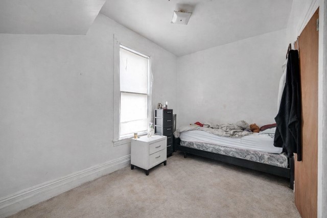 6237 South May Street Chicago, IL 60621 - Photo 4 of 14 a bedroom with bed and window