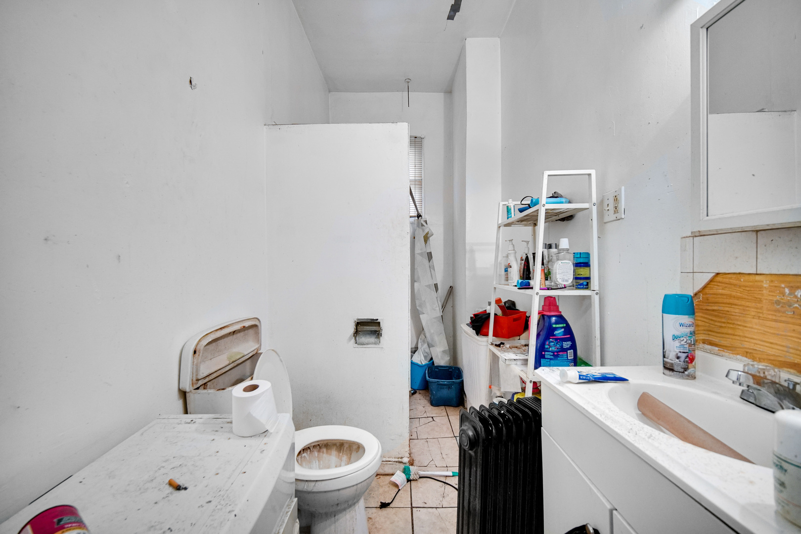 6237 South May Street Chicago, IL 60621 - Photo 10 of 14 a bathroom with a sink toilet vanity and tub