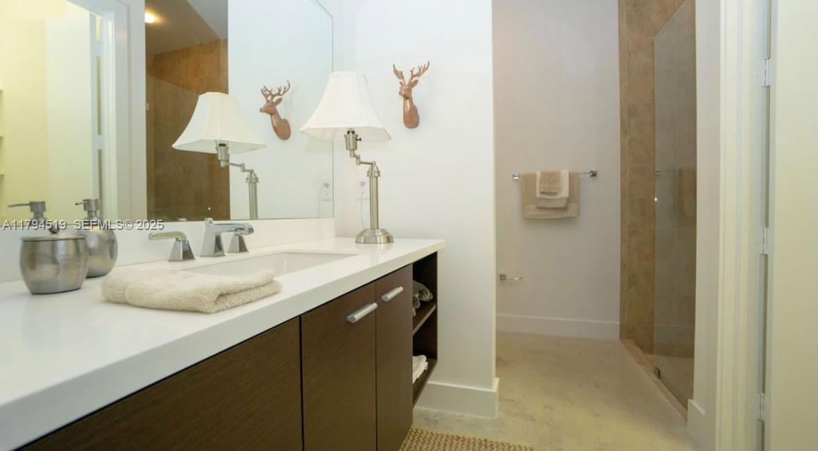 1901 Southeast Ranch Road South Jupiter, FL 33478 - Photo 28 of 53 a bathroom with a sink and a mirror