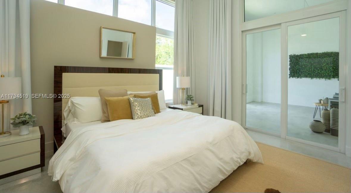 1901 Southeast Ranch Road South Jupiter, FL 33478 - Photo 29 of 53 a bedroom with a bed and a mirror