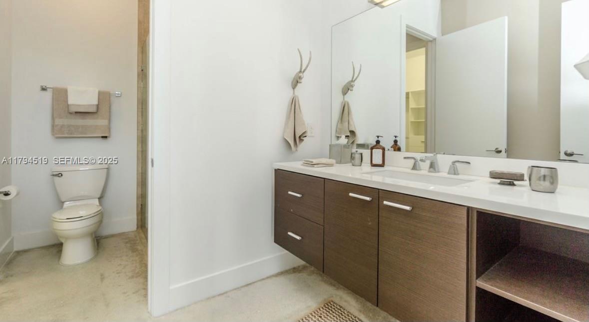 1901 Southeast Ranch Road South Jupiter, FL 33478 - Photo 30 of 53 a bathroom with a double vanity sink and a toilet