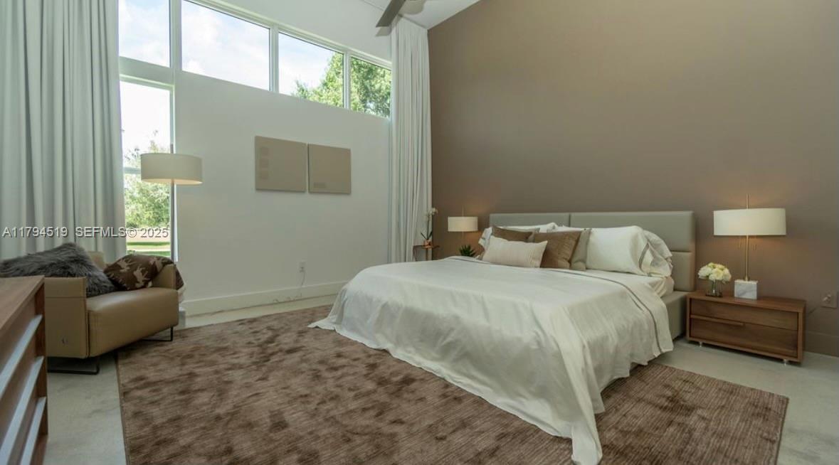 1901 Southeast Ranch Road South Jupiter, FL 33478 - Photo 31 of 53 a bedroom with a bed and a couch