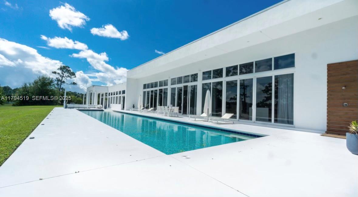 1901 Southeast Ranch Road South Jupiter, FL 33478 - Photo 44 of 53 a view of a house with a swimming pool