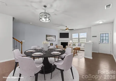 a dining room with furniture a chandelier and wooden floor
