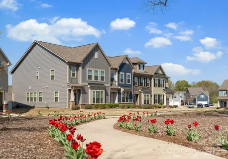 a front view of a multi story residential apartment building with garage