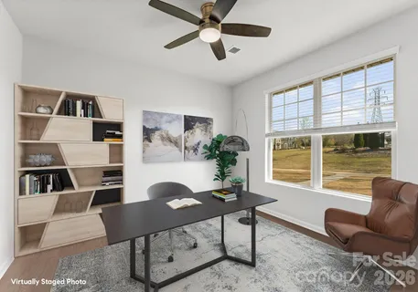 a living room with furniture a window and a potted plant