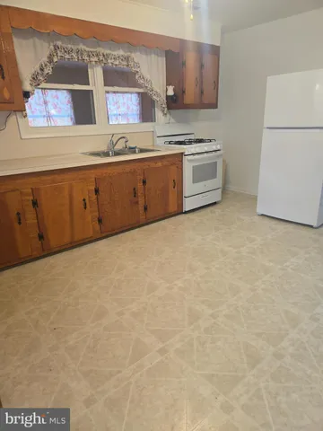 a kitchen with granite countertop white cabinets and stainless steel appliances