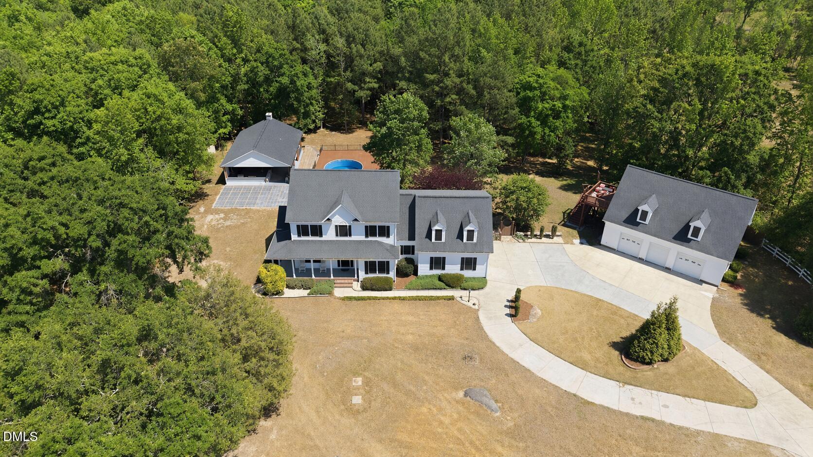 5416 Pulley Town Road Zebulon, NC 27597 - Photo 44 of 74 an aerial view of a house with swimming pool and large trees