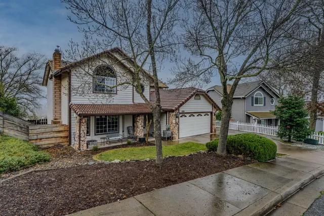 a front view of a house with garden