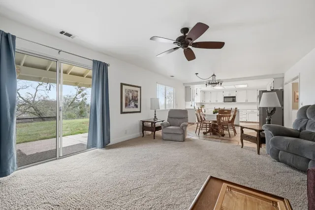 a bathroom with a sink a toilet a mirror and shower