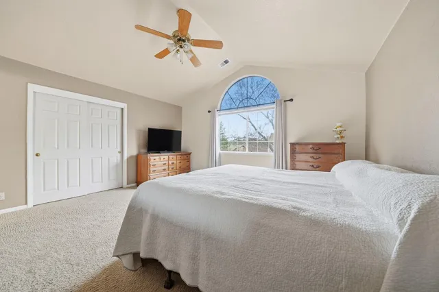 a front view of a house with patio and garden