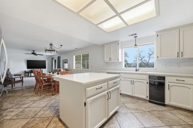 a kitchen with granite countertop cabinets stainless steel appliances and a window