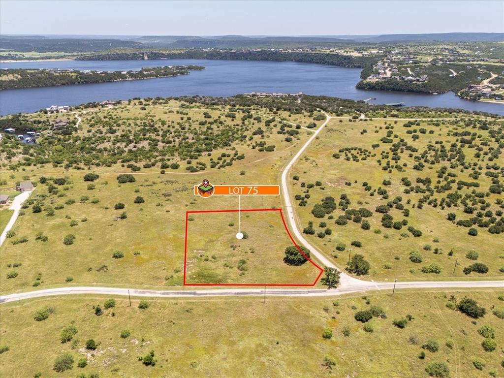 Lot 75 Lake Shore Loop Graford, TX 76449 - Photo 14 of 21 Aerial view of property's location with a large body of water and property parcel outlined