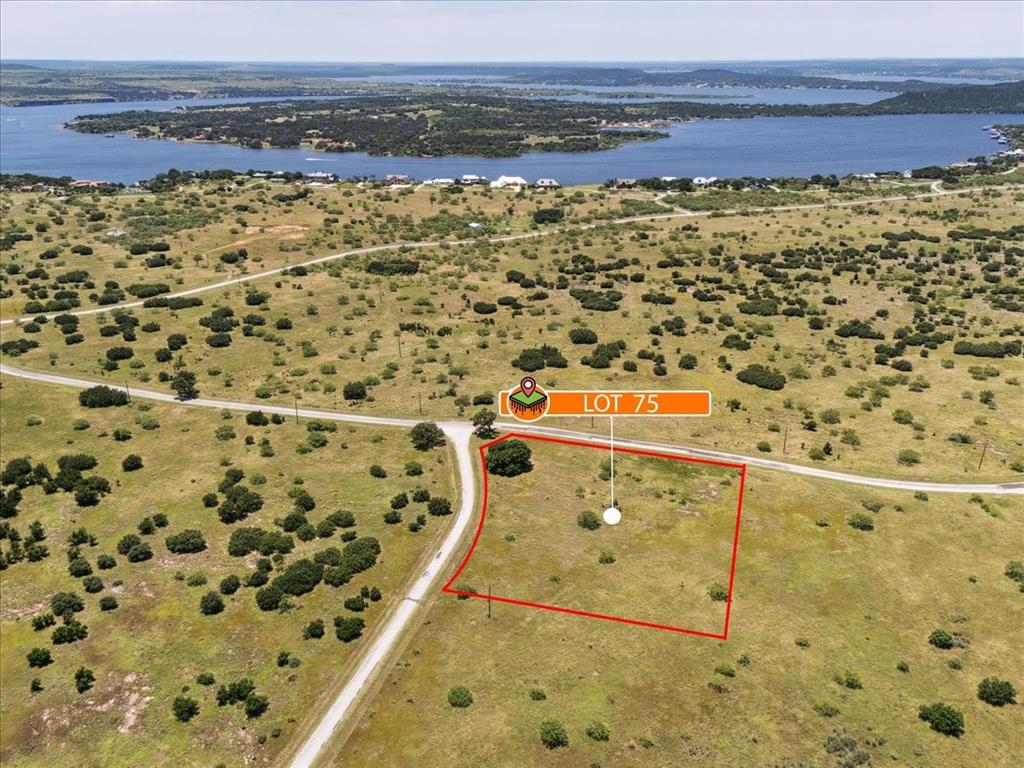 Lot 75 Lake Shore Loop Graford, TX 76449 - Photo 16 of 21 Aerial view of property and surrounding area featuring a nearby body of water and property boundaries highlighted