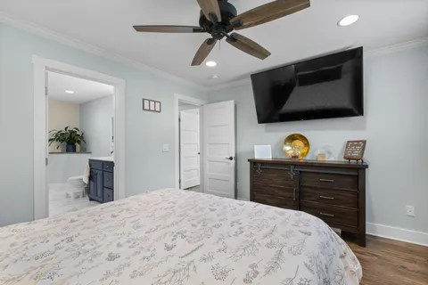 a bedroom with a bed and a flat screen tv
