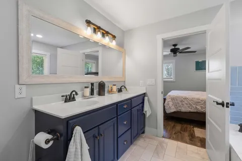 a en suite bathroom with a double vanity sink and a mirror